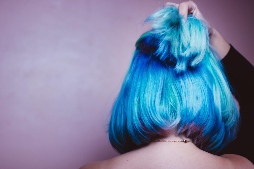 What does dyed blue hair symbolize?