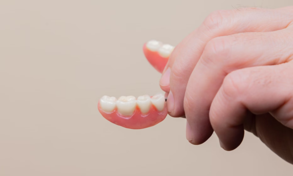 What is the easiest way to get denture adhesive off your gums?